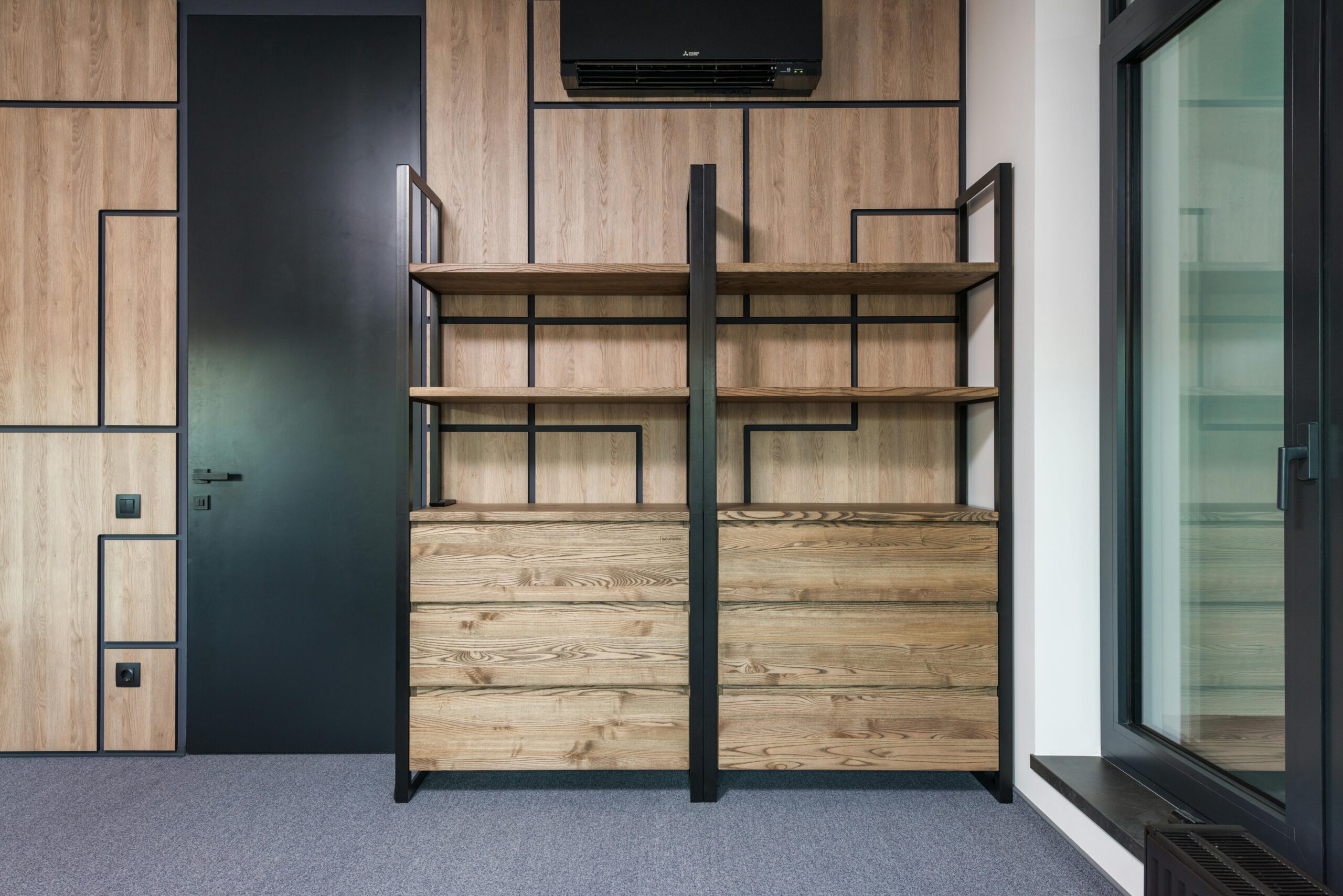 Contemporary interior design featuring wooden shelves and geometric patterns for home or office space.